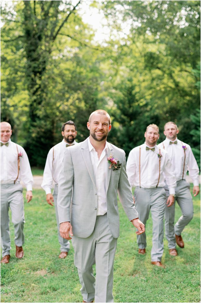 Fall Boho Wedding groom with groomsmen walking