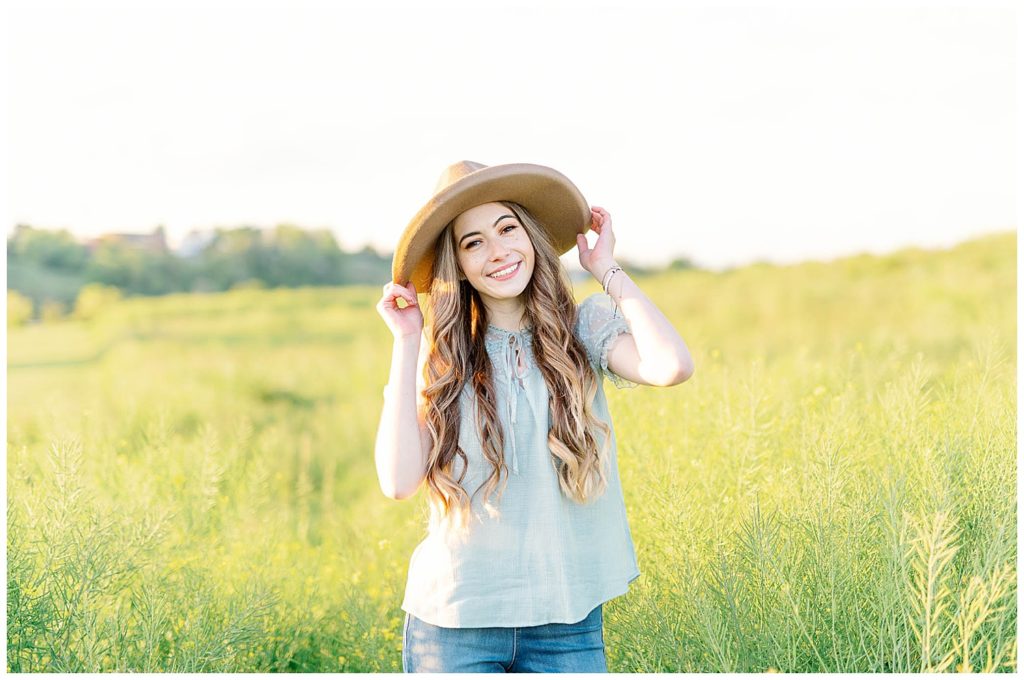 Spring High School Senior at Cherokee Trail Portrait with hat and tall grass
