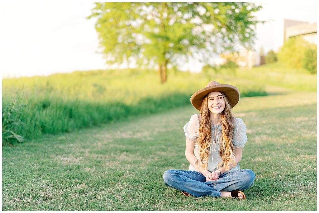 Spring High School Senior at Cherokee Trail Portrait on grass with hat