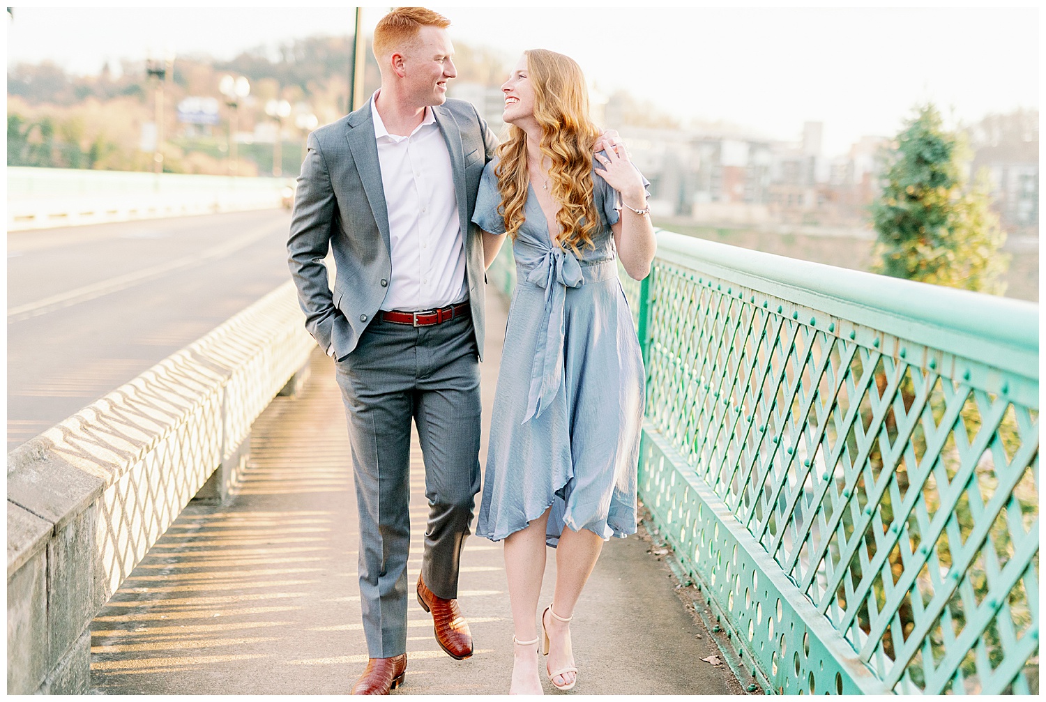 Classy downtown engagement session walking together on the bridge 
