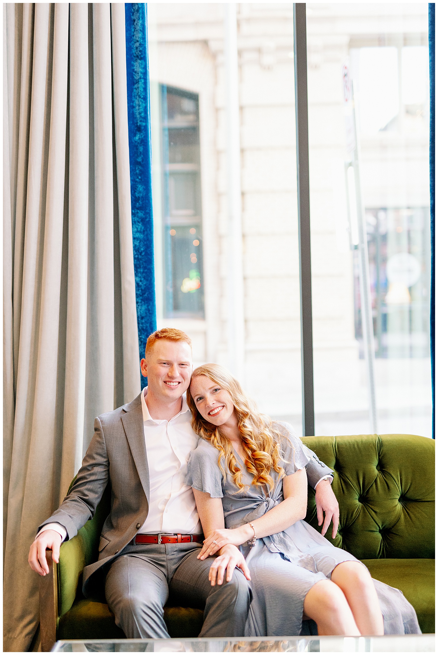 winter engagement session rachel and cameron on the green couch smiling 
