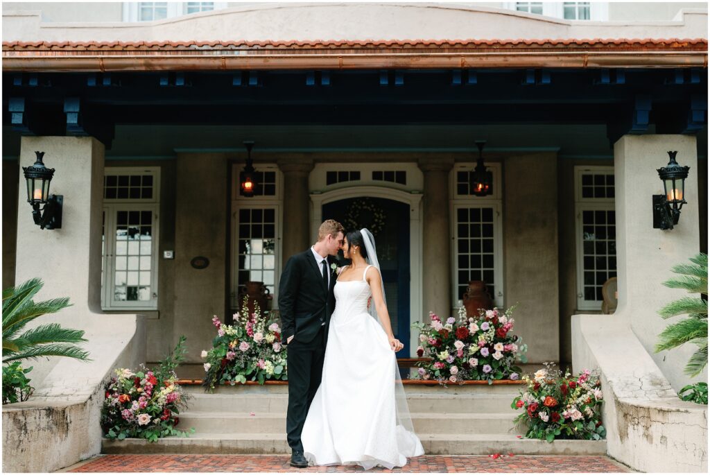 Bride and Groom in front of the Mansion embracing each other in Orlando Florida 